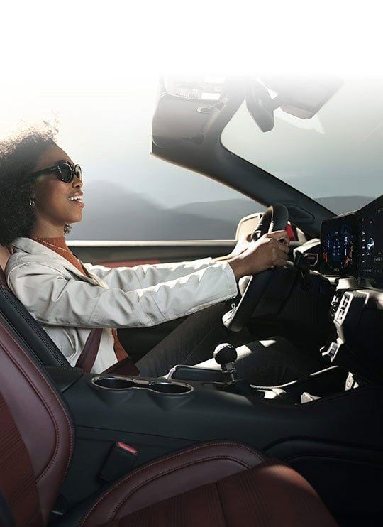 Person sitting in the driver’s seat of a 2024 Ford Mustang® convertible | Pohanka Ford of Salisbury in Salisbury MD