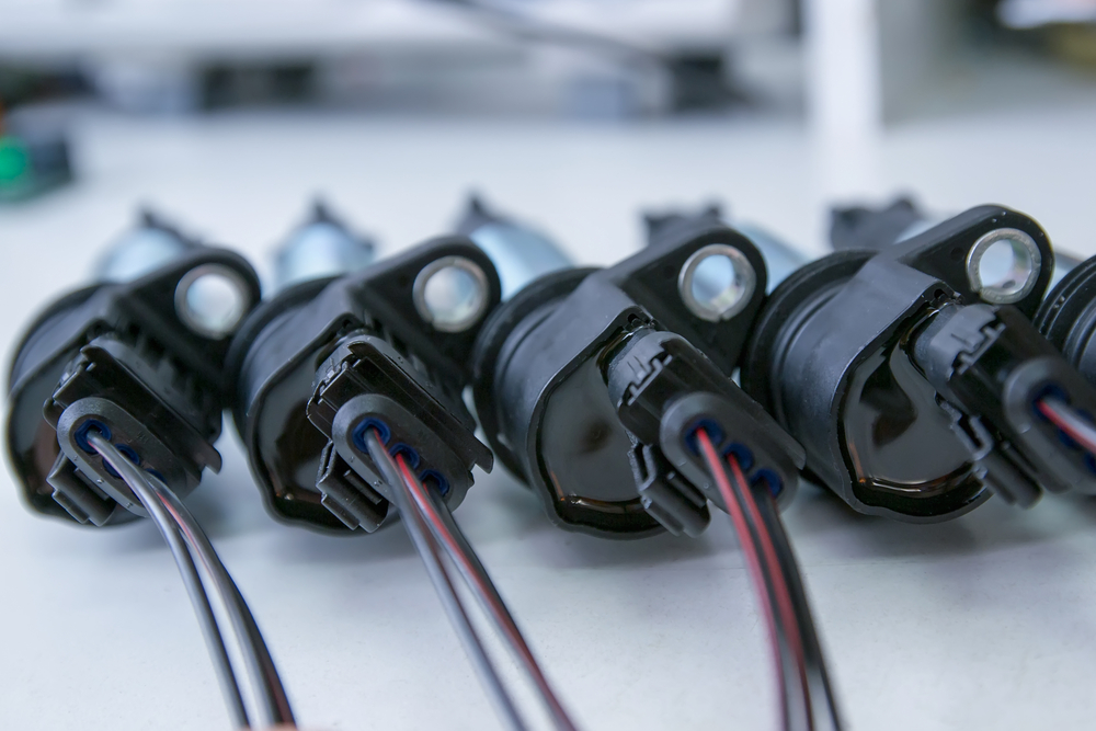 A row of ignition coils sitting on a flat surface