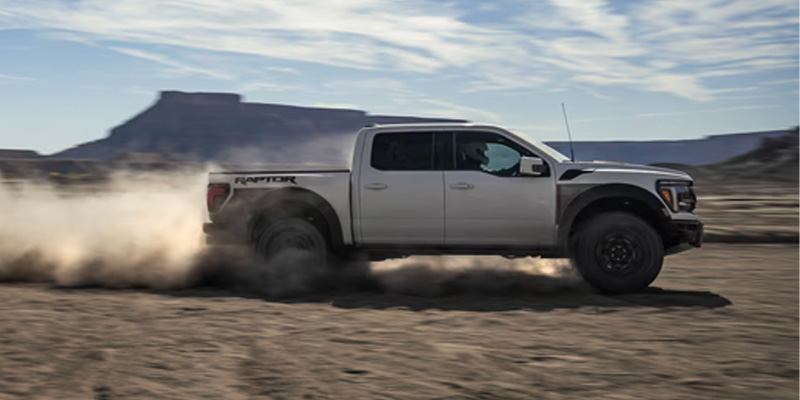 A white 2025 Ford F-150 driving through the desert.