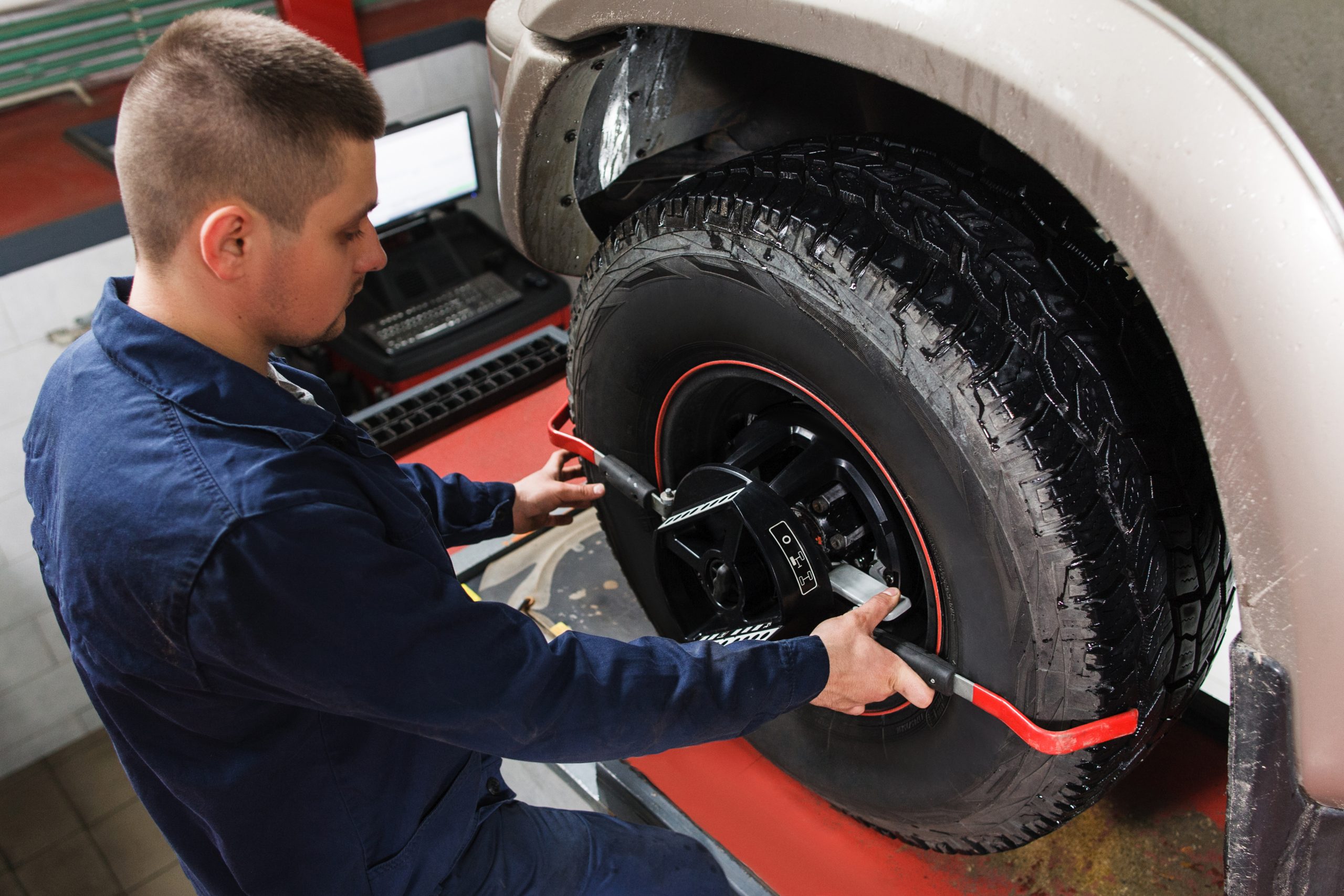 A photo of a service tech completing a tire alignment